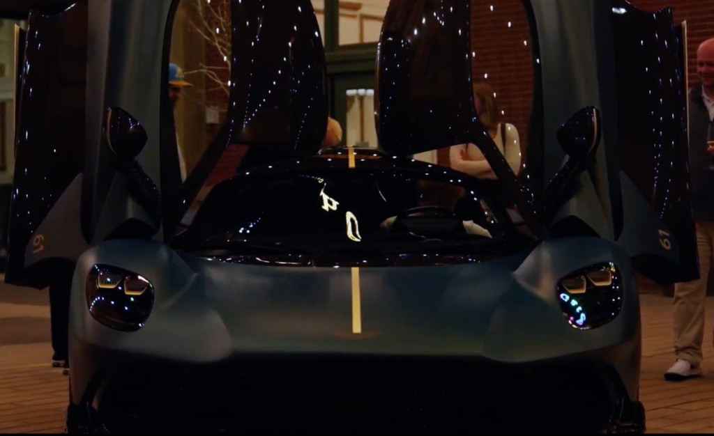 Matte teal Aston Martin Valhalla with dihedral doors open at night